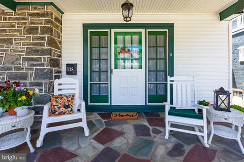 a front view of a house with outdoor seating and plants