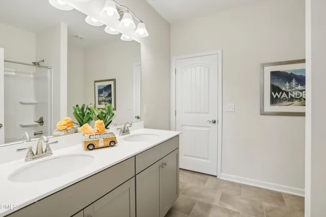 a bathroom with a double vanity sink and a mirror
