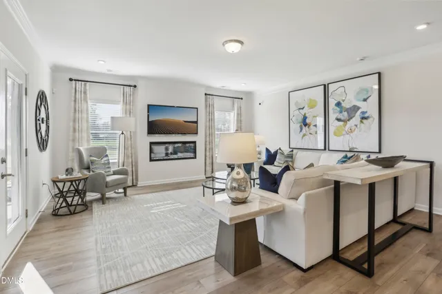 a living room with furniture a large window and a flat screen tv