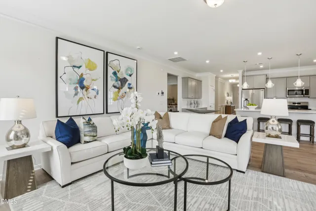 a living room with furniture and a painting on the wall