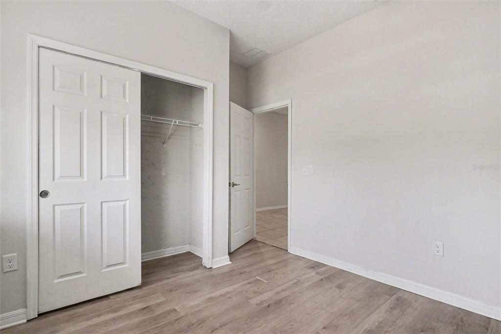 2735 Rowan Street Tavares, FL 32778 - Photo 15 of 32 an empty room with wooden floor & closet area