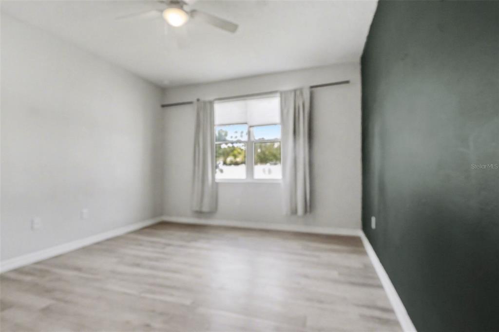 2735 Rowan Street Tavares, FL 32778 - Photo 20 of 32 wooden floor in an empty room with a window
