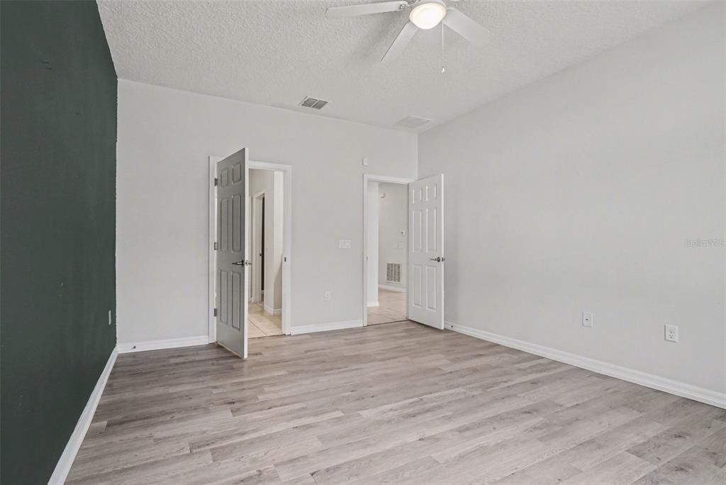 2735 Rowan Street Tavares, FL 32778 - Photo 21 of 32 a view of an empty room with wooden floor