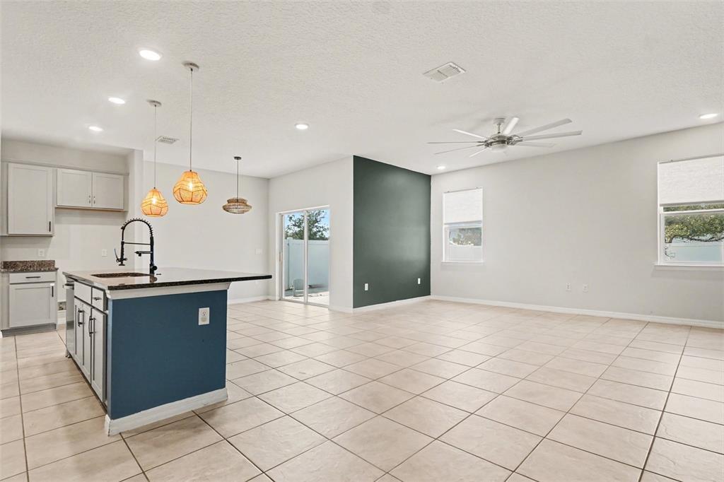 2735 Rowan Street Tavares, FL 32778 - Photo 6 of 32 a kitchen with stainless steel appliances granite countertop a sink and cabinets