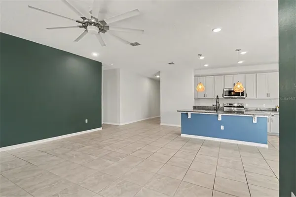 a kitchen with stainless steel appliances granite countertop a refrigerator a sink and dishwasher