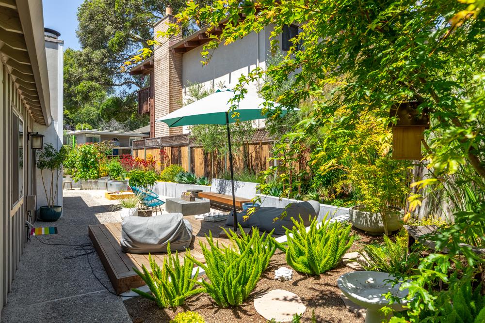 220 Aptos Beach Drive Aptos, CA 95003 - Photo 21 of 21 a view of a patio with table and chairs potted plants and a palm tree