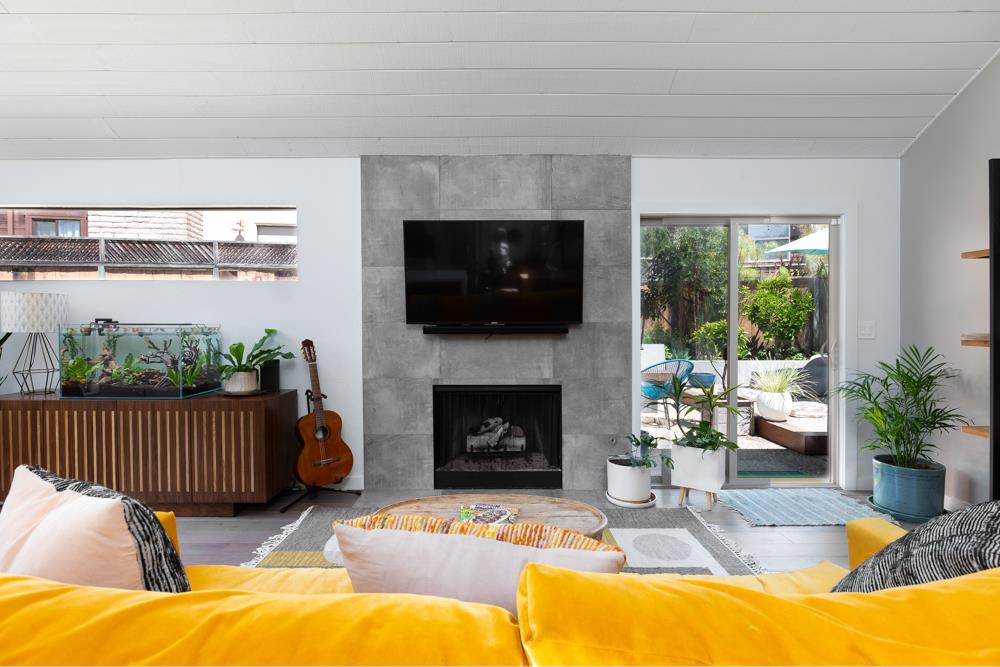 220 Aptos Beach Drive Aptos, CA 95003 - Photo 3 of 21 a living room with furniture a flat screen tv and a fireplace