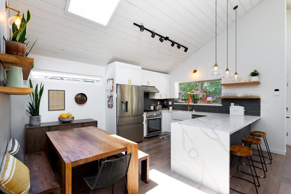 220 Aptos Beach Drive Aptos, CA 95003 - Photo 6 of 21 a kitchen with stainless steel appliances kitchen island granite countertop a table chairs and a refrigerator