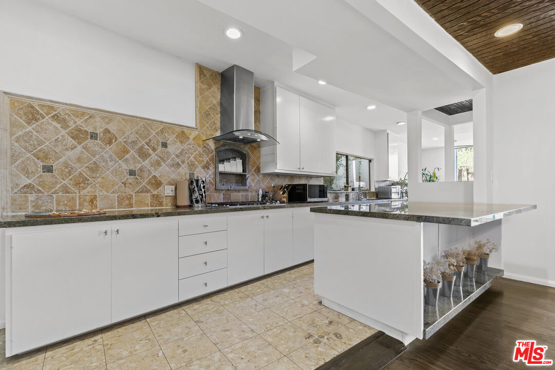 13952 Valley Vista Boulevard Sherman Oaks, CA 91423 - Photo 13 of 44 a kitchen with stainless steel appliances a sink stove and cabinets