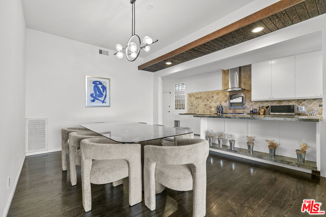 13952 Valley Vista Boulevard Sherman Oaks, CA 91423 - Photo 16 of 44 a dining table chair and a refrigerator in a kitchen