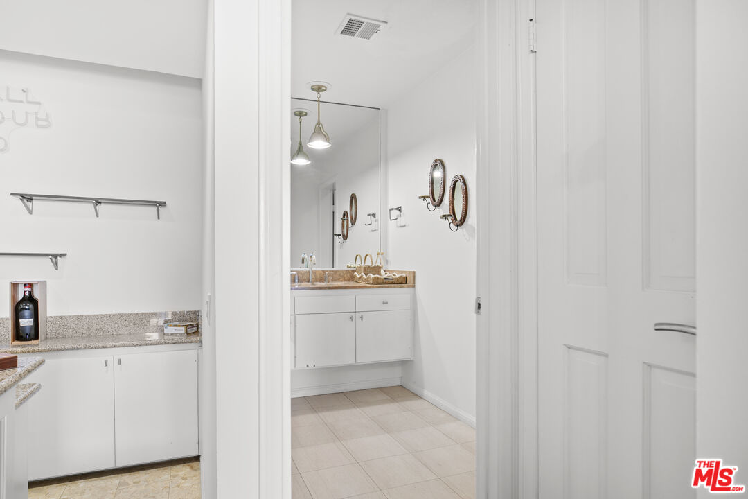 13952 Valley Vista Boulevard Sherman Oaks, CA 91423 - Photo 26 of 44 a bathroom with a sink and a mirror