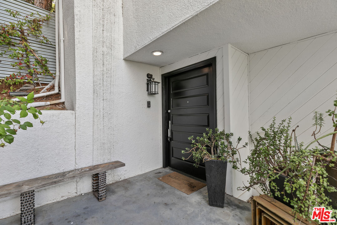 13952 Valley Vista Boulevard Sherman Oaks, CA 91423 - Photo 28 of 44 a living room with a potted plant and a window
