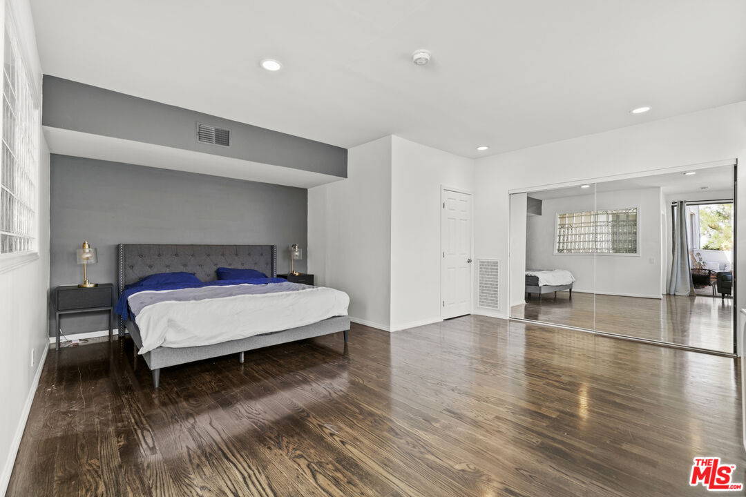 13952 Valley Vista Boulevard Sherman Oaks, CA 91423 - Photo 35 of 44 a bedroom with a bed and wooden floor