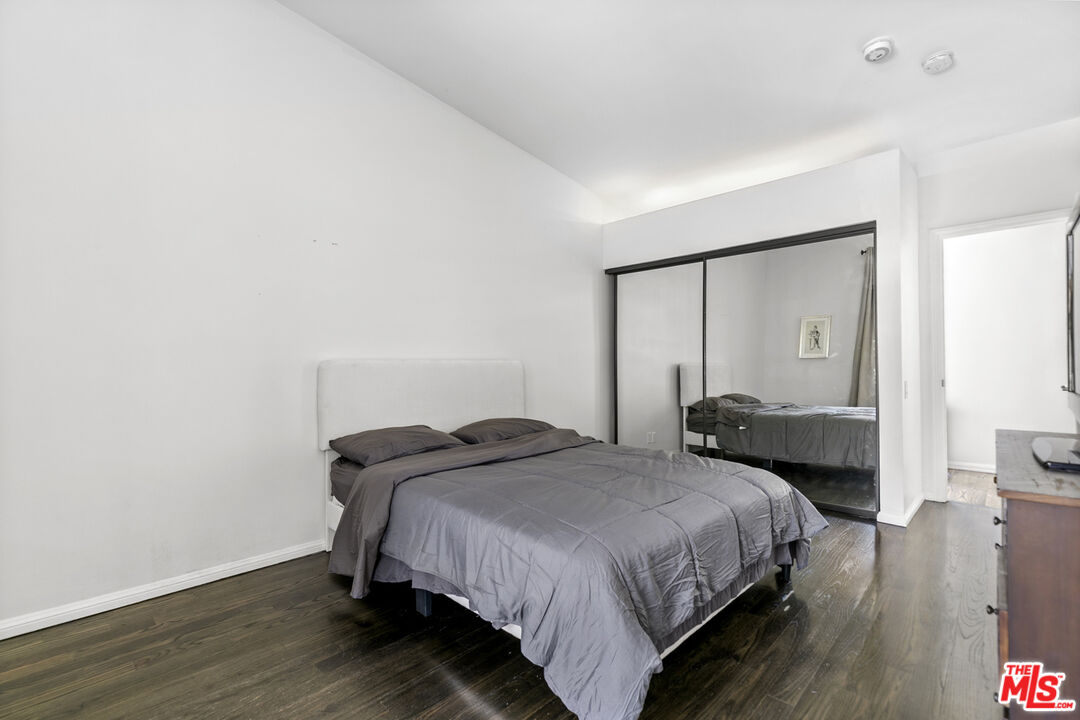 13952 Valley Vista Boulevard Sherman Oaks, CA 91423 - Photo 36 of 44 a bedroom with a bed and wooden floor