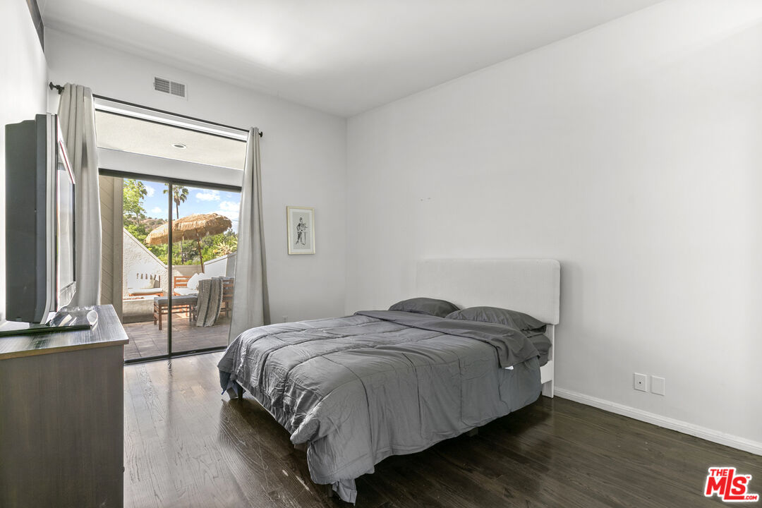 13952 Valley Vista Boulevard Sherman Oaks, CA 91423 - Photo 37 of 44 a bedroom with a bed and a large window