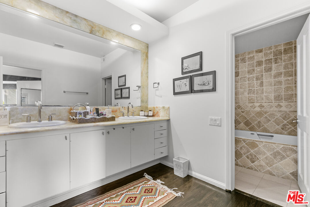 13952 Valley Vista Boulevard Sherman Oaks, CA 91423 - Photo 41 of 44 a spacious bathroom with a double vanity sink a mirror and a shower