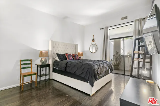 a spacious bedroom with a bed and a table in it