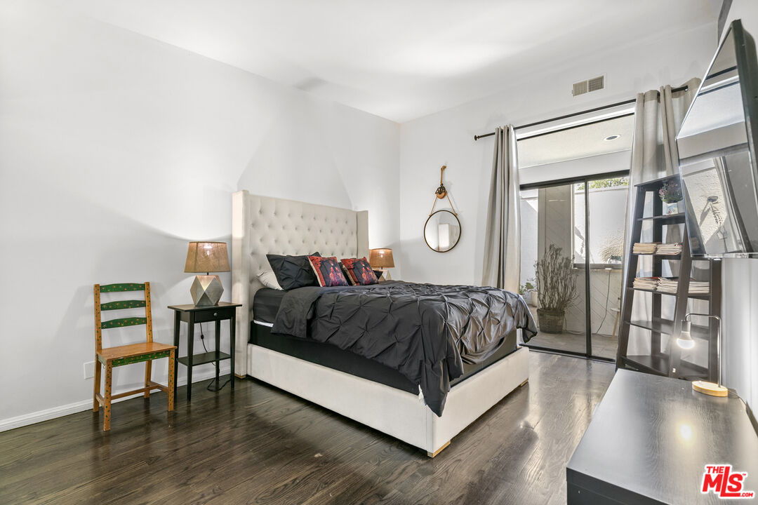 13952 Valley Vista Boulevard Sherman Oaks, CA 91423 - Photo 43 of 44 a spacious bedroom with a bed and a table in it