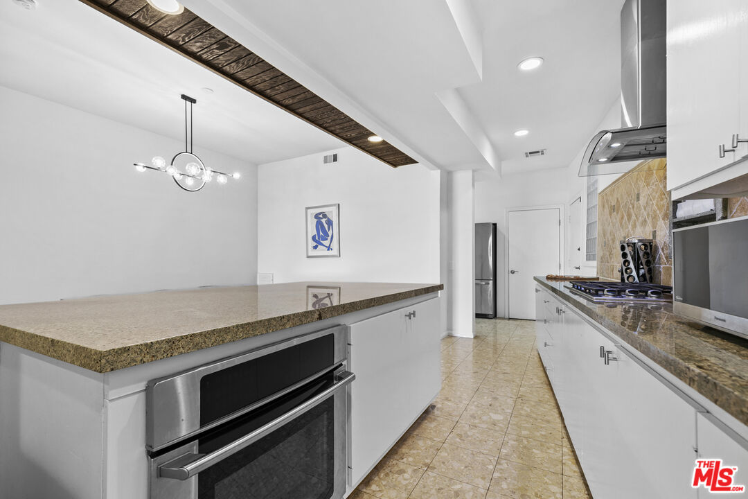 13952 Valley Vista Boulevard Sherman Oaks, CA 91423 - Photo 6 of 44 a kitchen with a stove and a sink