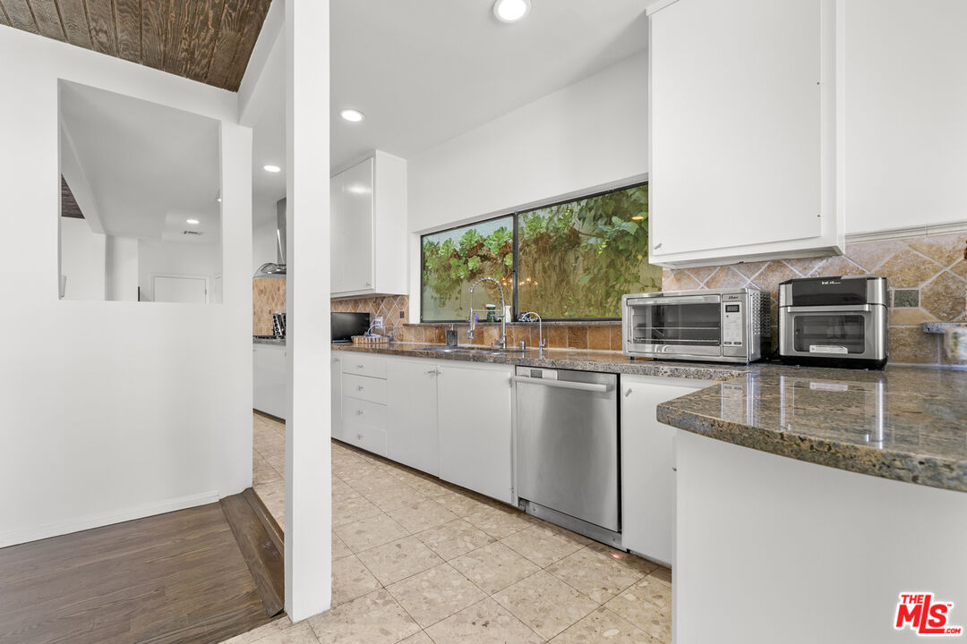 13952 Valley Vista Boulevard Sherman Oaks, CA 91423 - Photo 8 of 44 a kitchen with stainless steel appliances granite countertop a sink and a stove