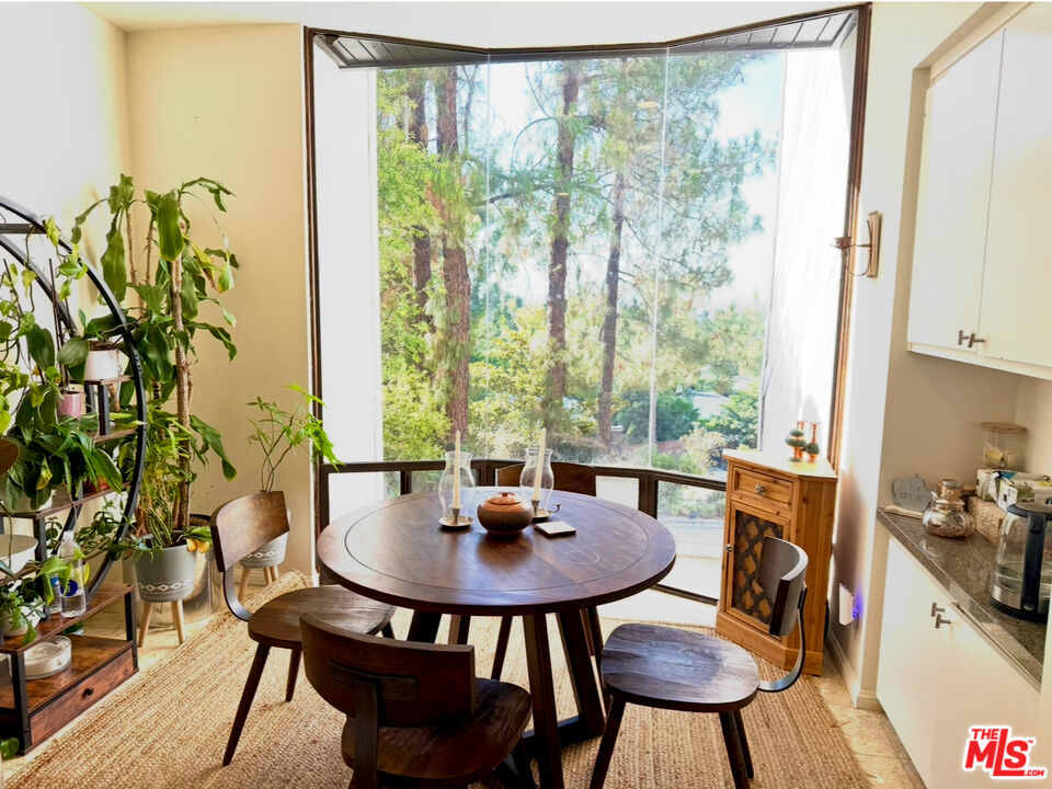 13952 Valley Vista Boulevard Sherman Oaks, CA 91423 - Photo 9 of 44 a view of a dining room with furniture window and wooden floor