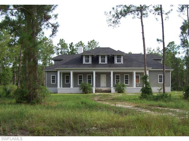 4620 8th Avenue Northeast Naples, FL 34120 - Photo 1 of 8 a front view of house with a garden