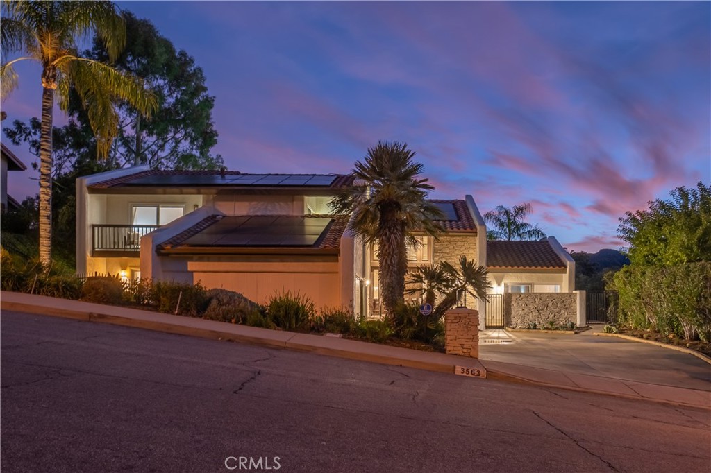 3563 Twin Lake Westlake Village, CA 91361 - Photo 12 of 54 a front view of a house with a yard and garage