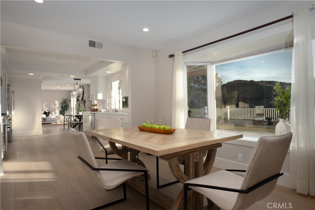 3563 Twin Lake Westlake Village, CA 91361 - Photo 16 of 54 a dining room with furniture and a floor to ceiling window