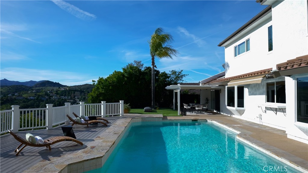 3563 Twin Lake Westlake Village, CA 91361 - Photo 6 of 54 a view of a patio with couches table and chairs with wooden floor and fence