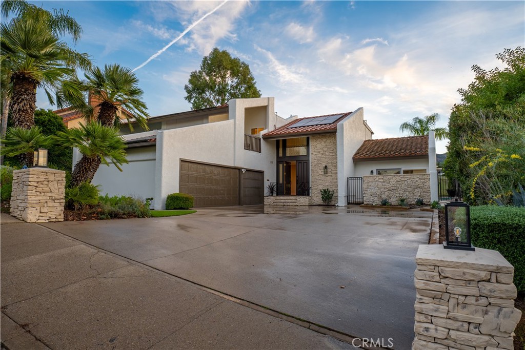 3563 Twin Lake Westlake Village, CA 91361 - Photo 10 of 54 a front view of a house with a yard and a garage
