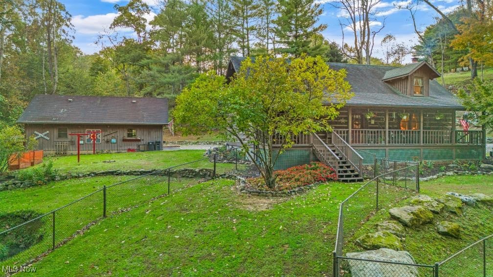 Back of property with a yard