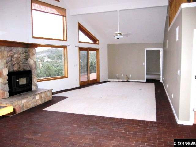 1850 Harte Road Reno, NV 89521 - Photo 5 of 9 an empty room with windows and fireplace