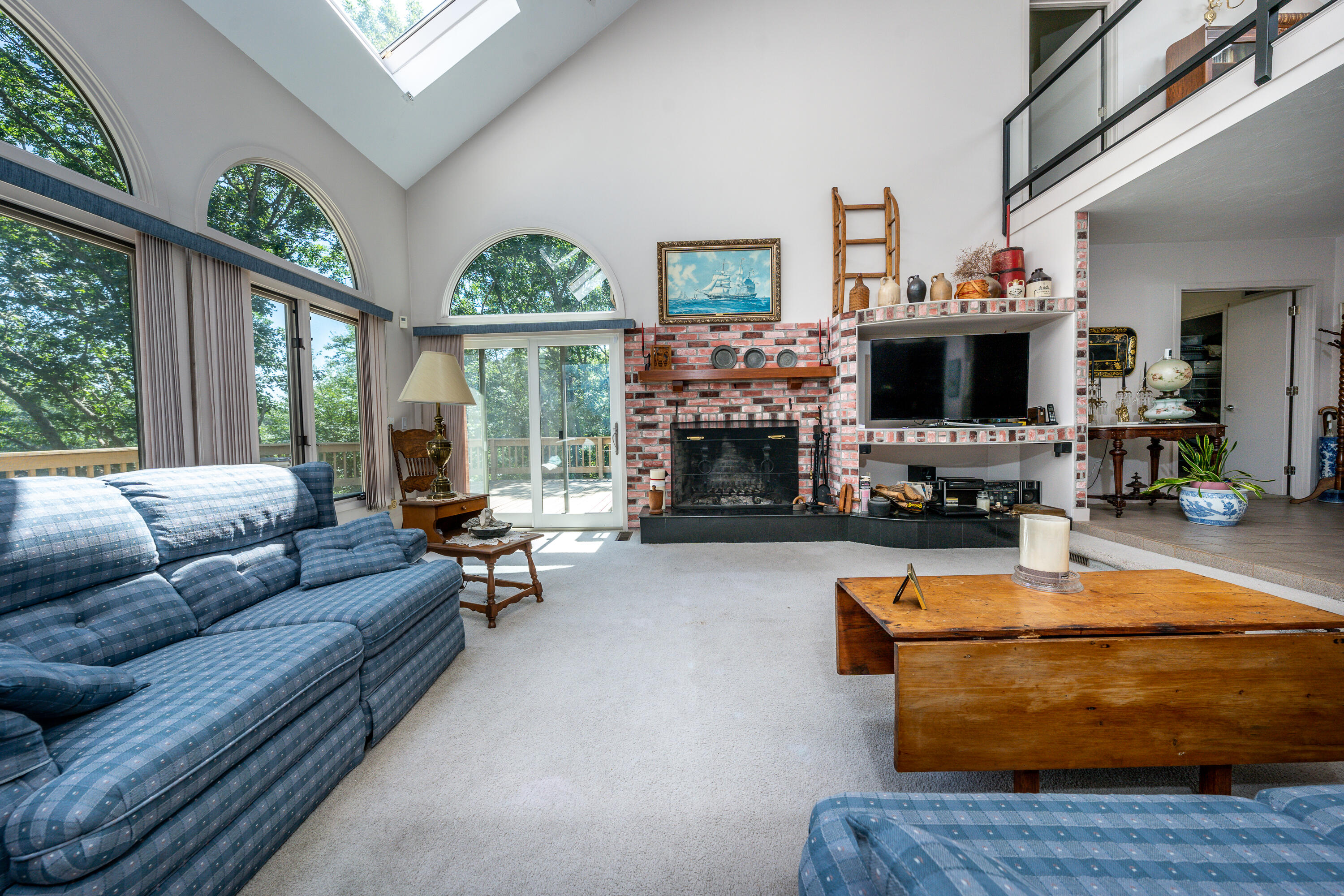 108 Waterside Drive Centerville, MA 02632 - Photo 15 of 64 a living room with fireplace furniture and a large window