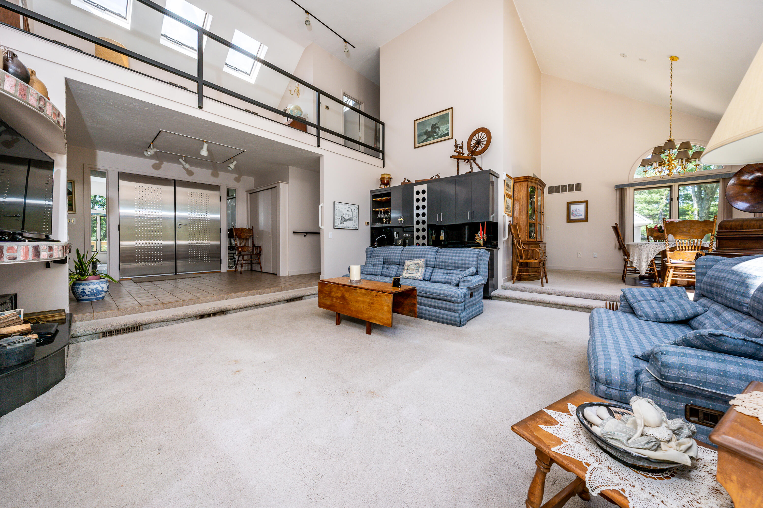 108 Waterside Drive Centerville, MA 02632 - Photo 20 of 64 a living room with furniture and a chandelier