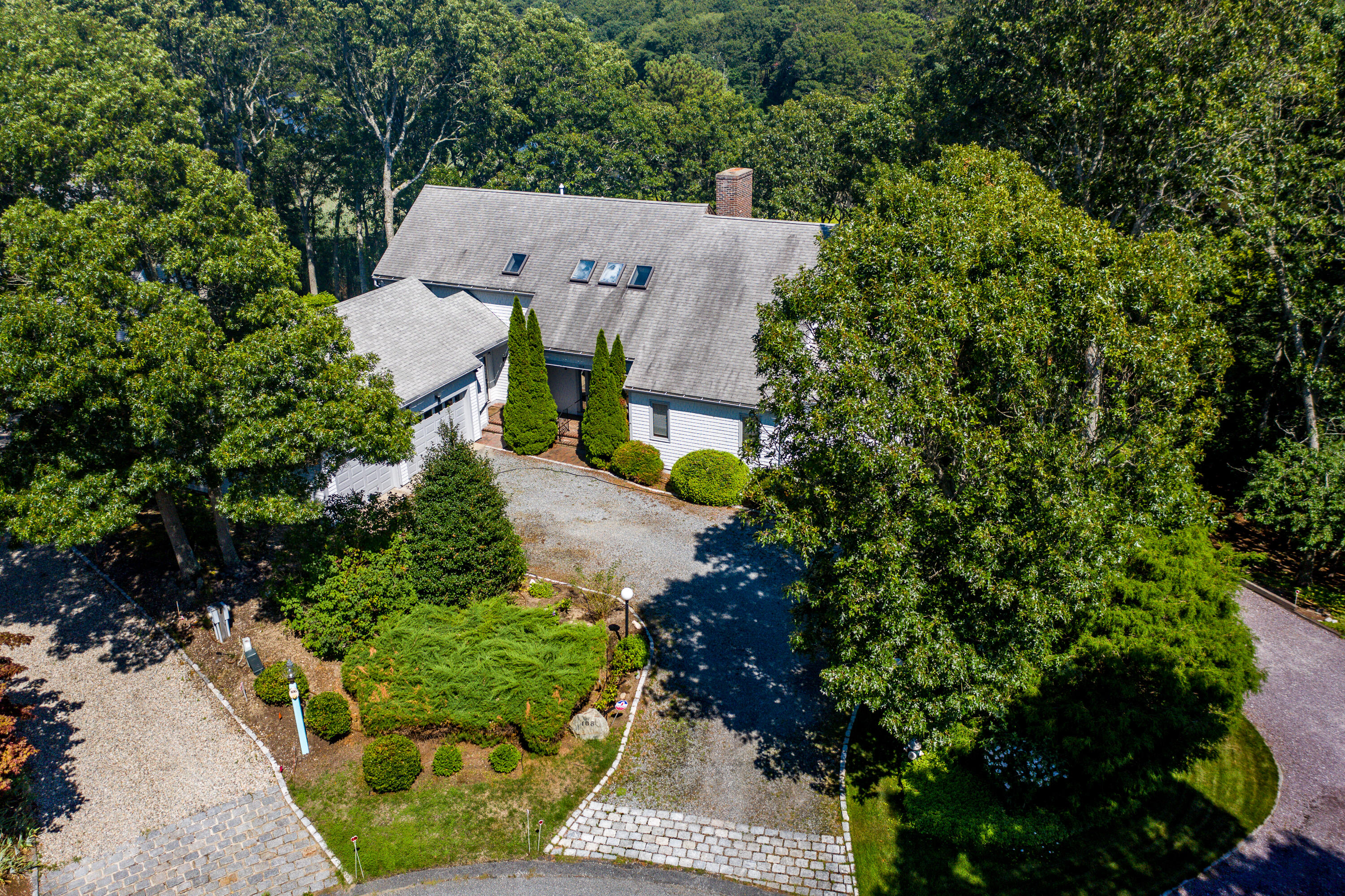 108 Waterside Drive Centerville, MA 02632 - Photo 2 of 64 an aerial view of a house with a yard and trees all around