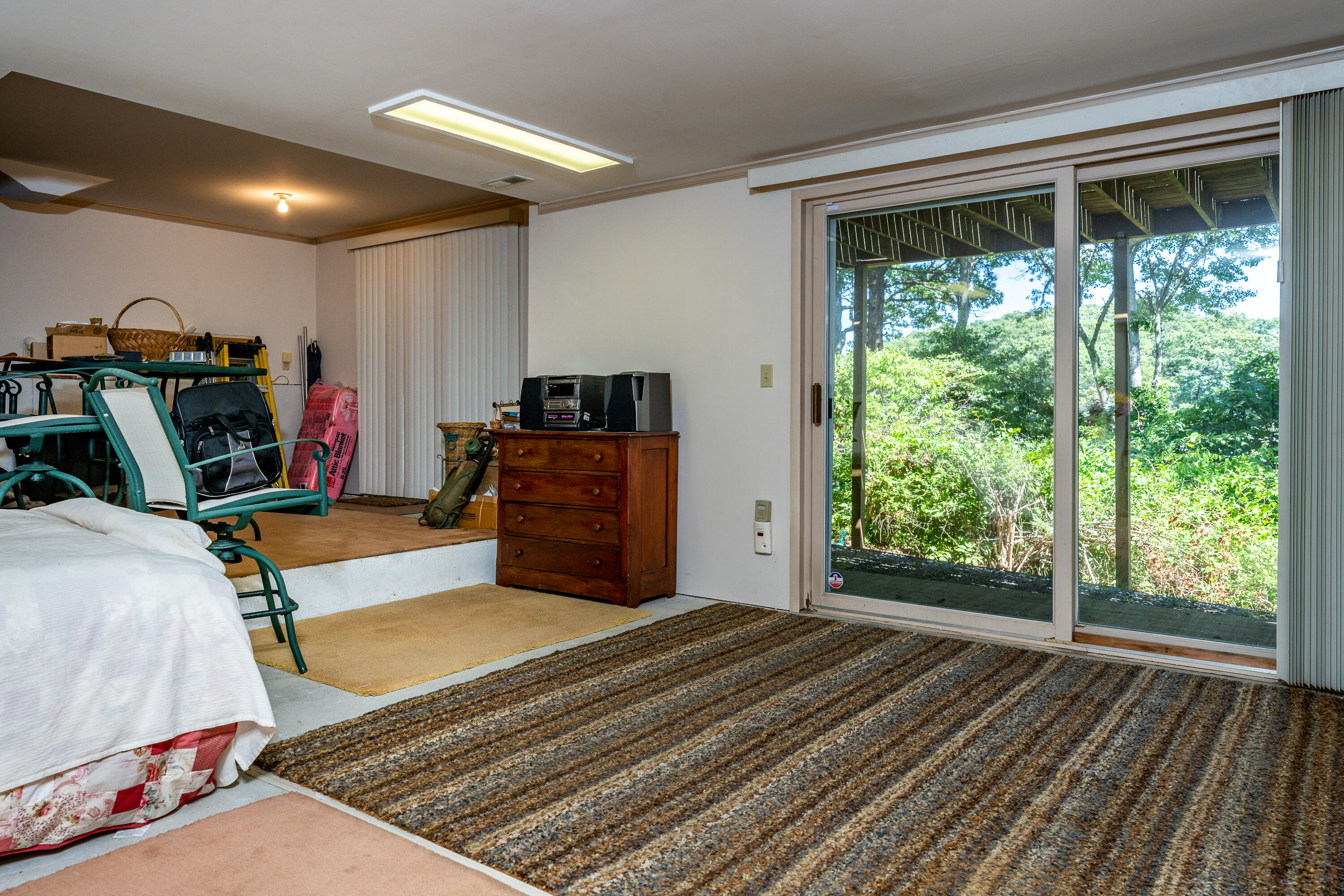 108 Waterside Drive Centerville, MA 02632 - Photo 49 of 64 a bedroom with a bed closet and a large window with garden view