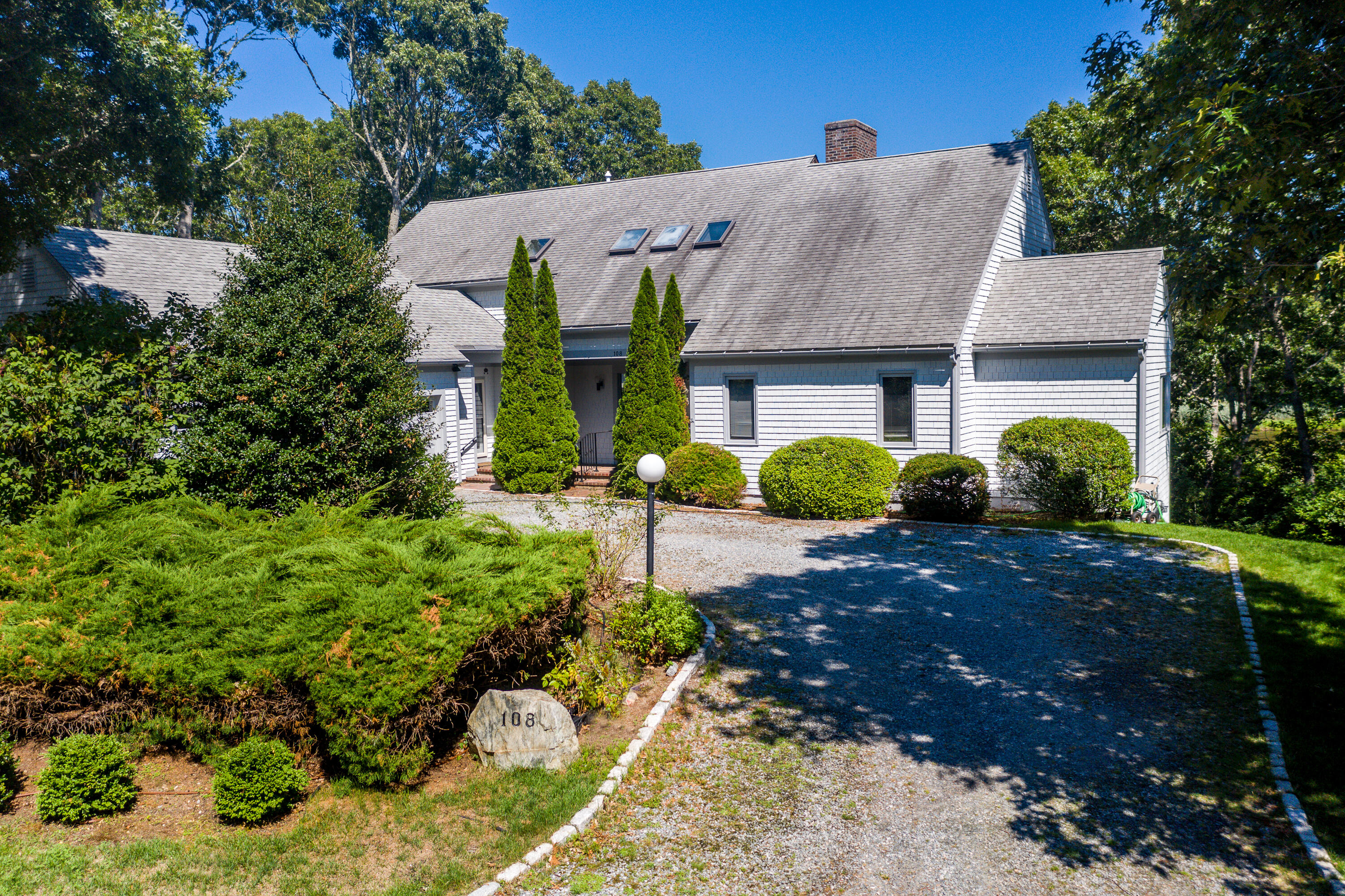 108 Waterside Drive Centerville, MA 02632 - Photo 51 of 64 a view of a big house with plants and large trees
