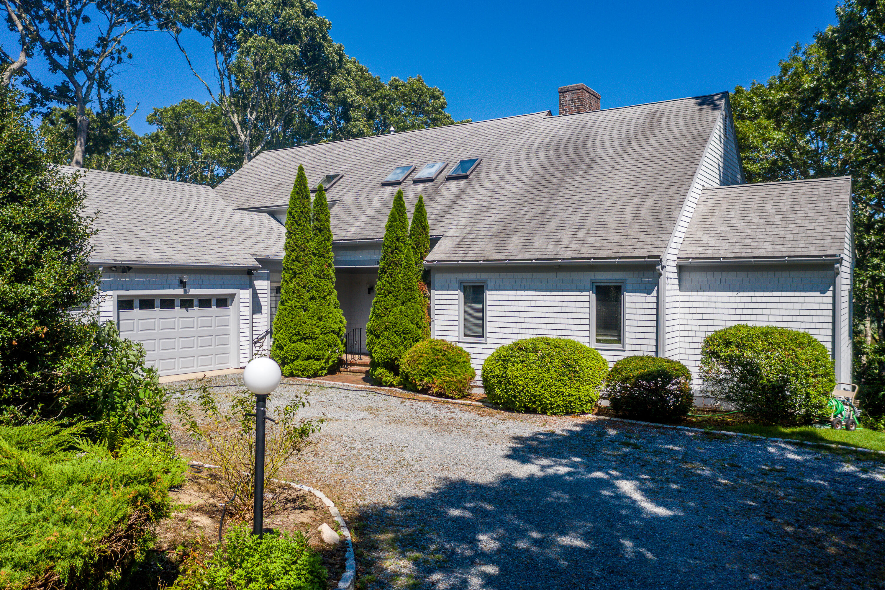 108 Waterside Drive Centerville, MA 02632 - Photo 52 of 64 a front view of a house with a yard and garage