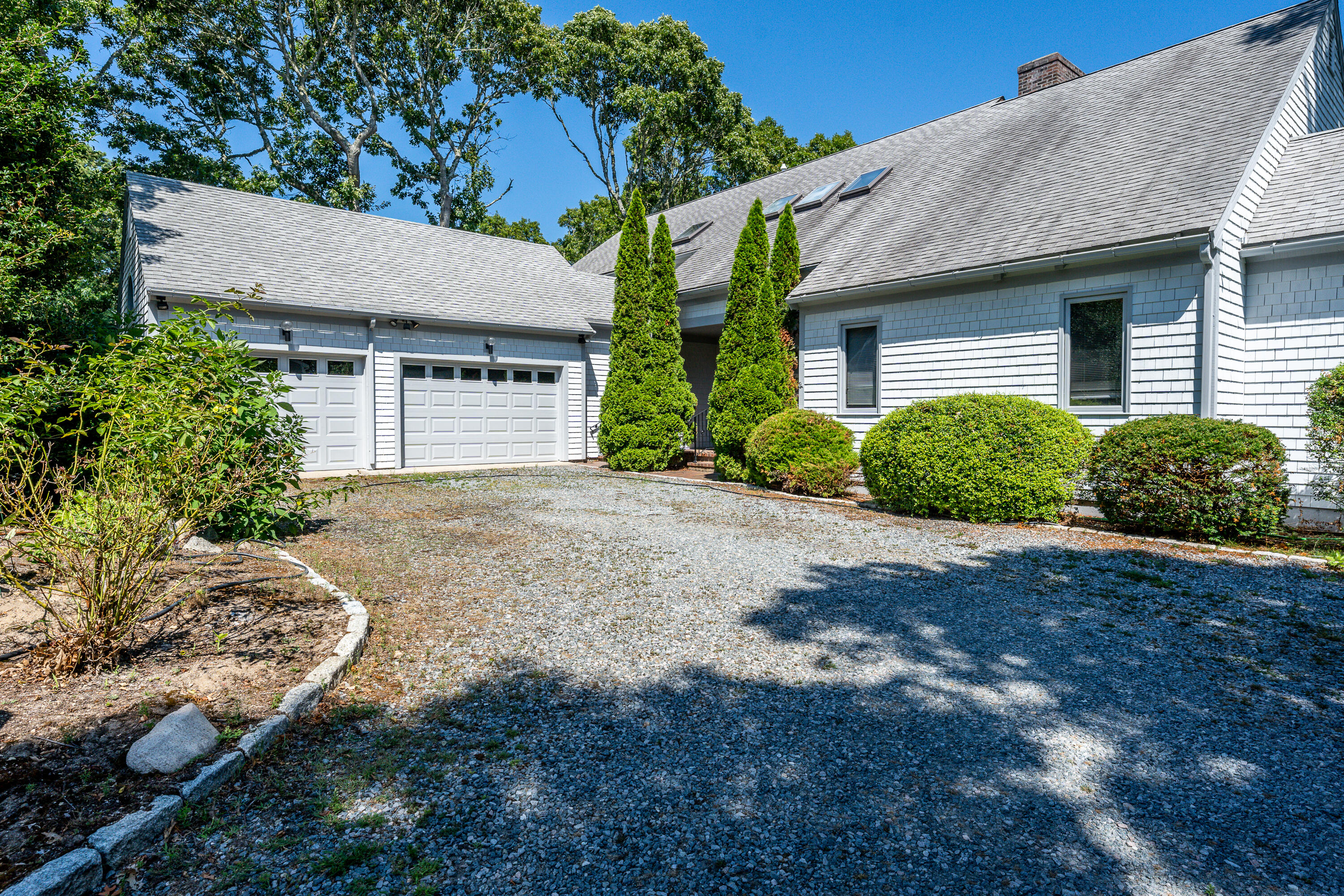108 Waterside Drive Centerville, MA 02632 - Photo 59 of 64 a front view of a house with a yard and potted plants