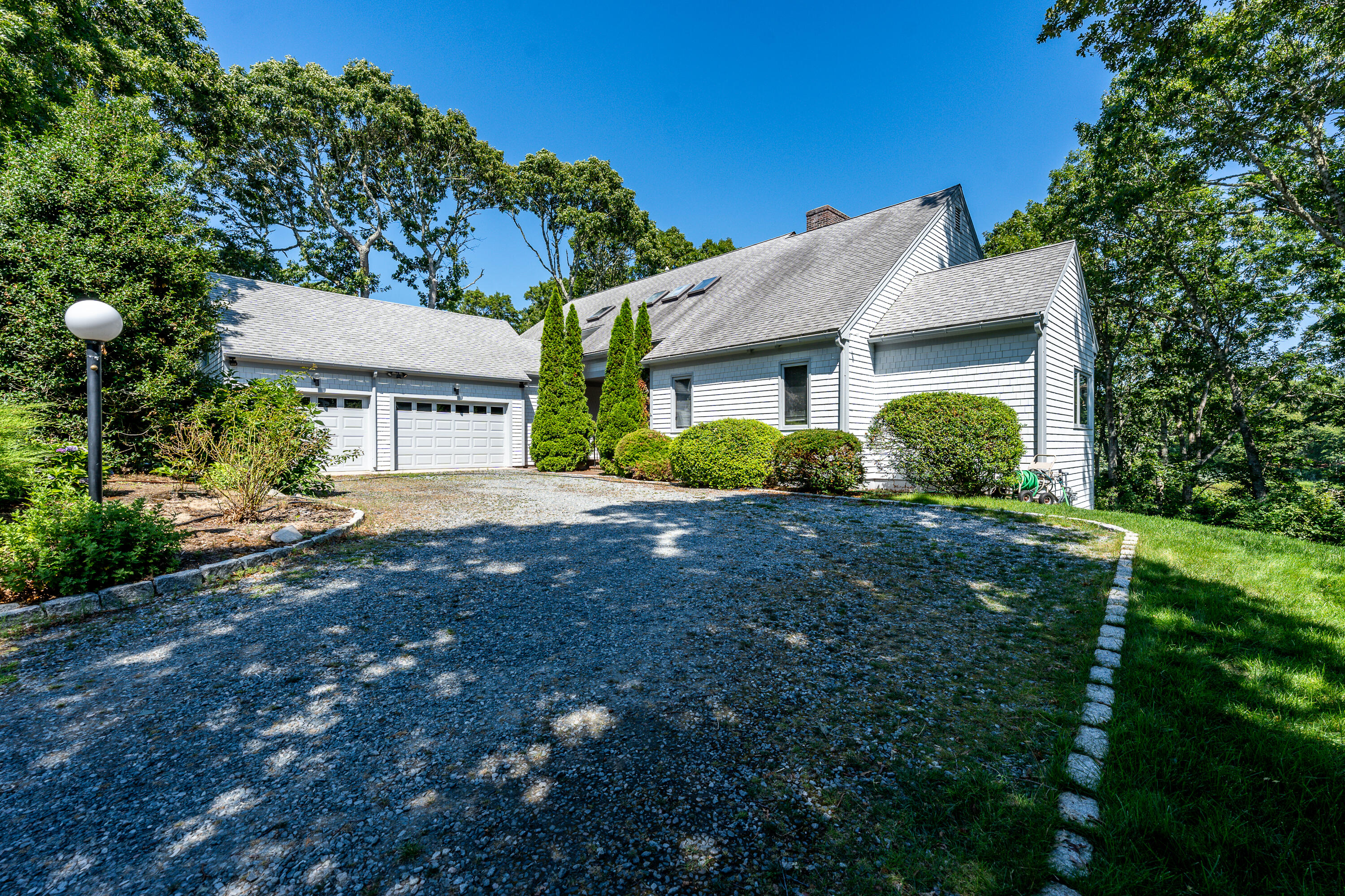 108 Waterside Drive Centerville, MA 02632 - Photo 61 of 64 a front view of a house with a garden
