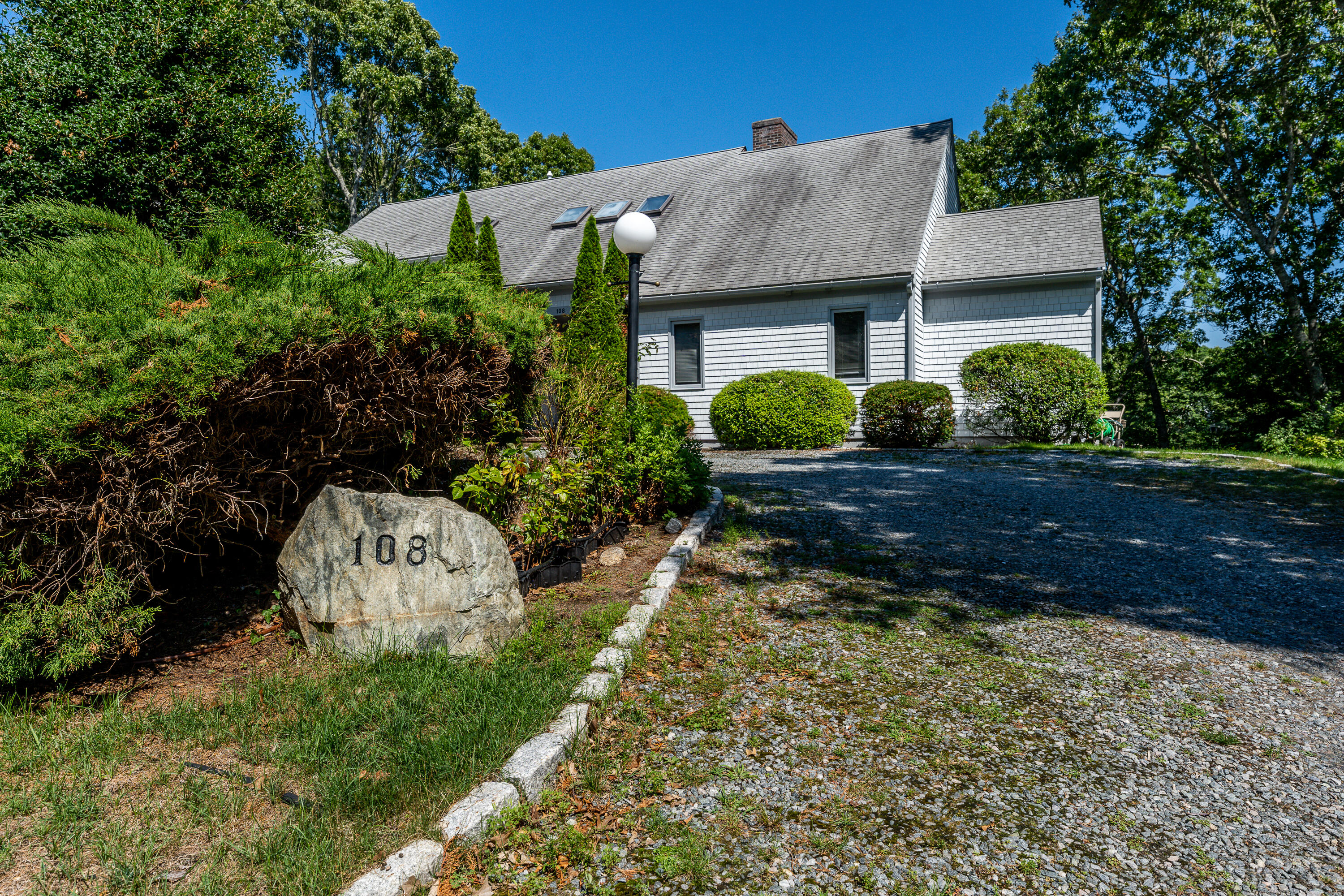108 Waterside Drive Centerville, MA 02632 - Photo 62 of 64 a front view of a house with a yard and a garden