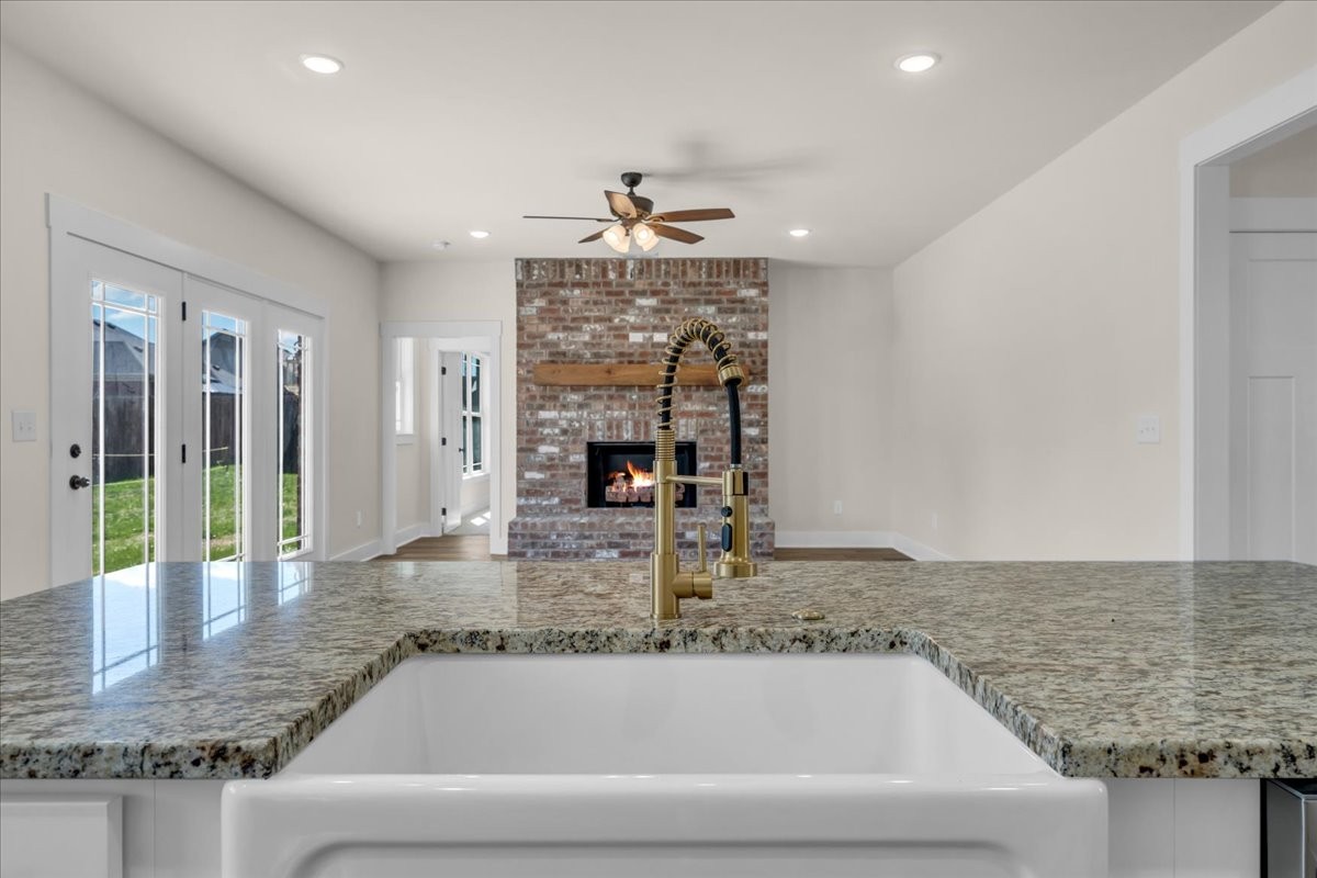 112 Riley Creek Road Tullahoma, TN 37388 - Photo 15 of 54 a view of a kitchen with granite countertop a sink a counter top space and living room view