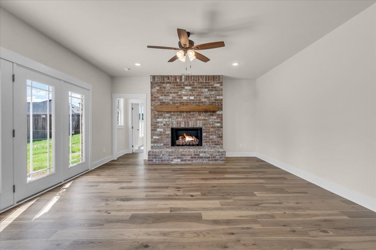 112 Riley Creek Road Tullahoma, TN 37388 - Photo 21 of 54 a view of an empty room with wooden floor fireplace and a window