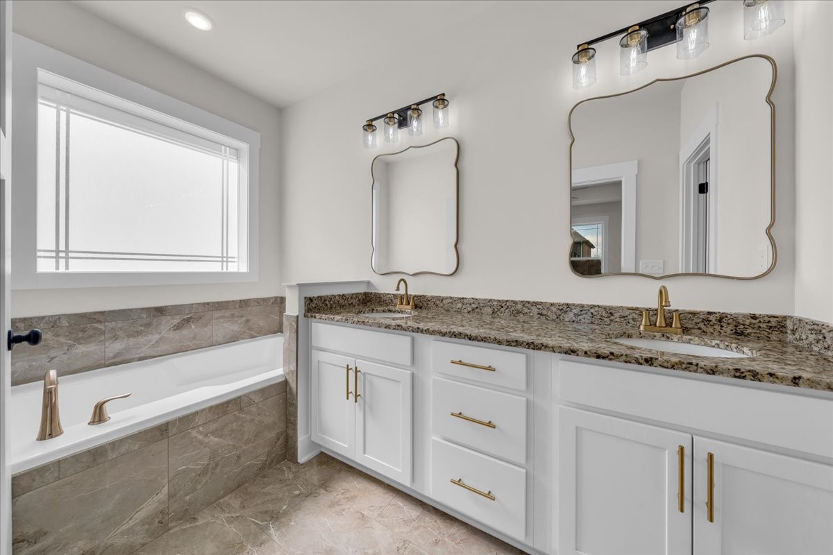 112 Riley Creek Road Tullahoma, TN 37388 - Photo 29 of 54 a bathroom with double vanity sinks and a bathtub
