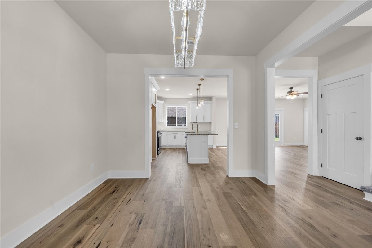 112 Riley Creek Road Tullahoma, TN 37388 - Photo 9 of 54 a view of a hallway with wooden floor and a kitchen