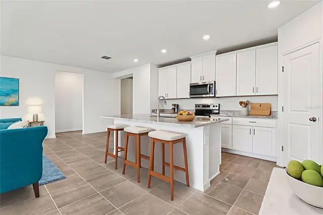 a kitchen with a sink a microwave and cabinets