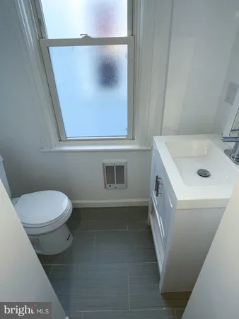 a bathroom with a toilet and a sink