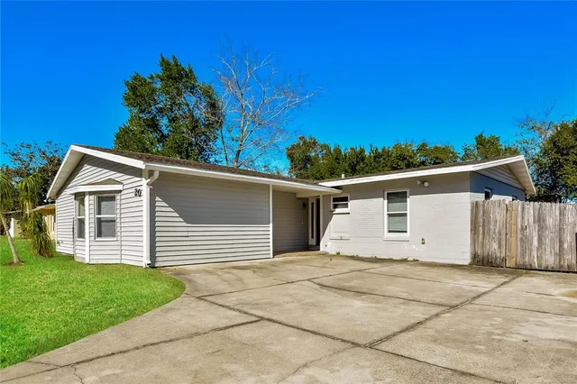 a view of a white house with a yard