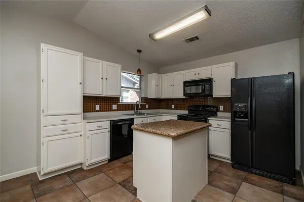 a kitchen with a refrigerator stove and sink