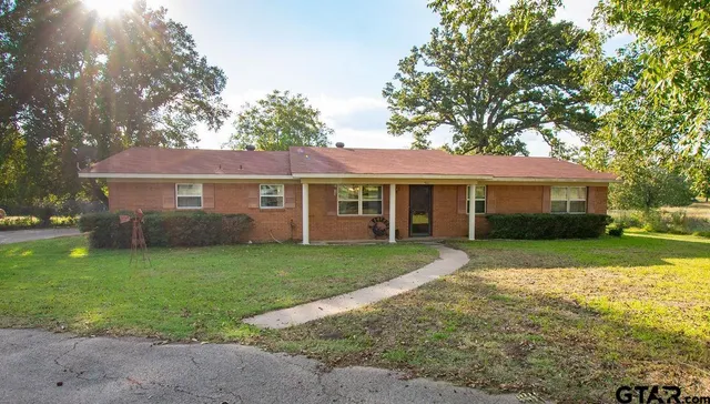 a front view of a house with a yard and porch